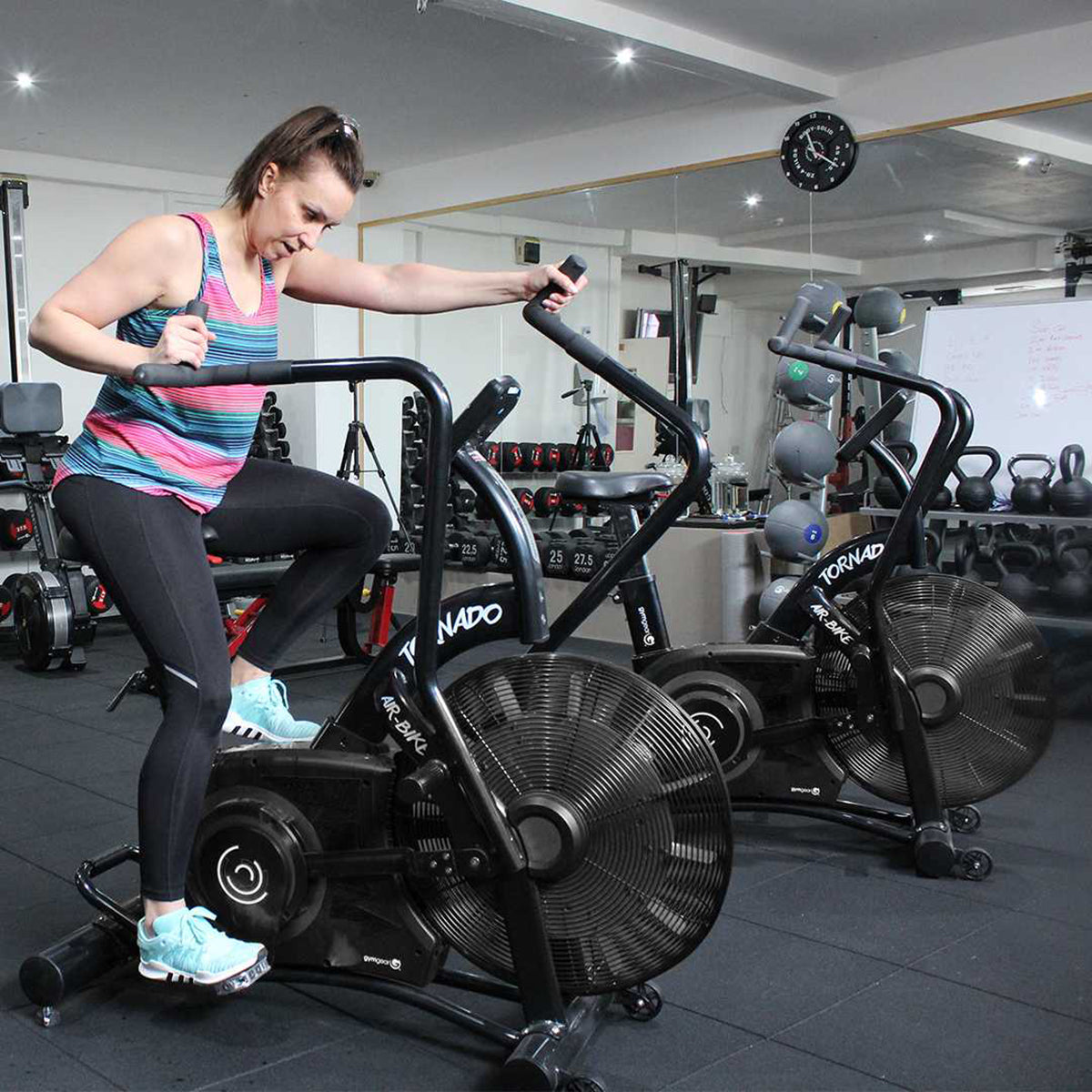 Tornado Airbike Black Edition. Female exercising on the bike 