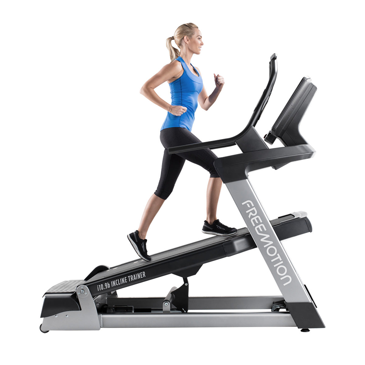 Freemotion i10.9b Incline Trainer showing person running at an incline from a side view