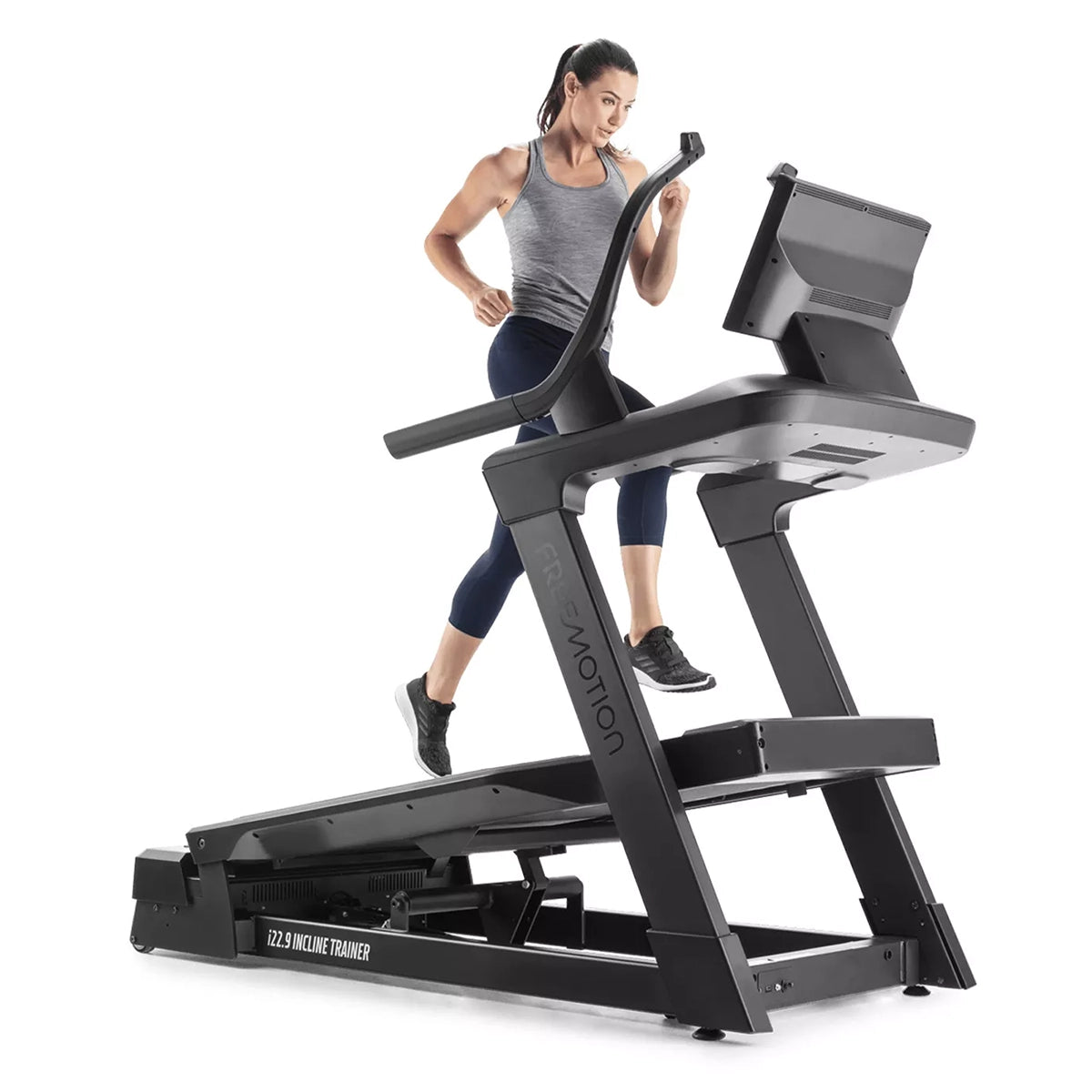 Freemotion i22.9 Incline treadmill Trainer in black and inclined, with a person running, from a front on view 